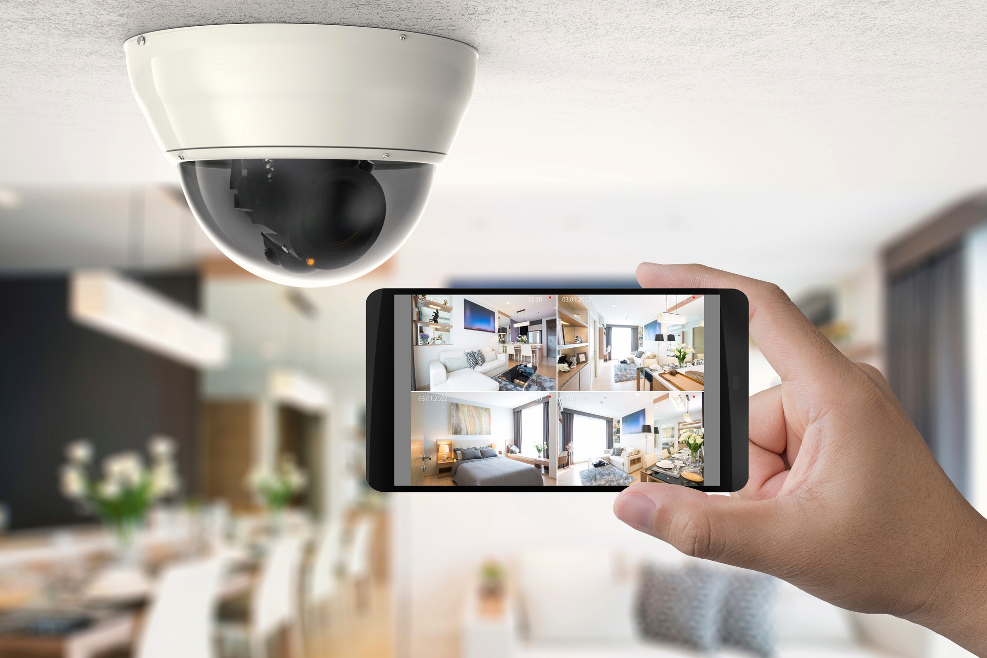 Hand Holding A Mobile Device That Is Connected To Security Cameras